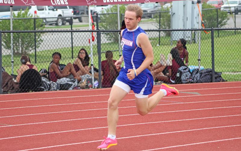 (TC GORDON | THE GRAHAM LEADER) Holton Weatherman rounds the turn during one of the distance runs at the district meet in Mineral Wells a few weeks ago. Weatherman participated in the 800-meter run at the area meet last week and qualified for regionals.