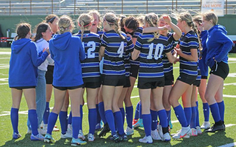 (TC GORDON | THE GRAHAM LEADER) The Lady Blues celebrate on the field after winning their first playoff game in program history. Many of the players received all-district awards for their work on the field and in the classroom in one of the best seasons in Graham Lady Blues soccer history.