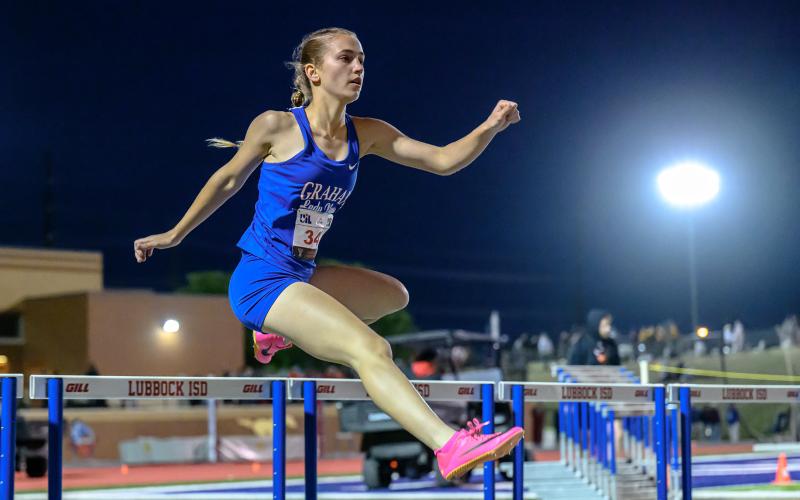 (DAVID FLYNN | CONTRIBUTED PHOTO) Ava Street leaps over a hurdle during the 300-meter hurdles event at the regional track meet in Lubbock last weekend. Street finished 10th in the preliminaries.