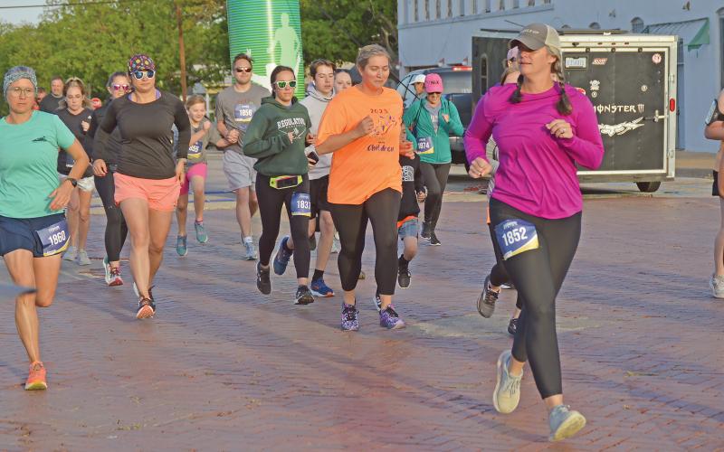 (THE GRAHAM LEADER | ARCHIVE PHOTO) Runners in the 5K race of the Run for the Children take off from the starting line at Third Street and Oak Street in 2023. The race this year will start and end at the same location Saturday, April 27.