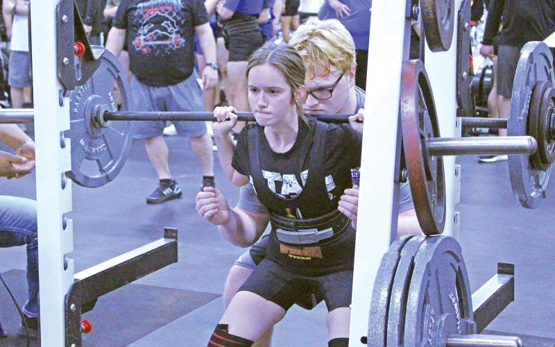 (TC GORDON | THE GRAHAM LEADER) Graham’s Hannah Hollingsworth executes her squat lift during a powerlifting meet in Graham. Hollingsworth was one of two Lady Blues to qualify for regionals in her weight class.