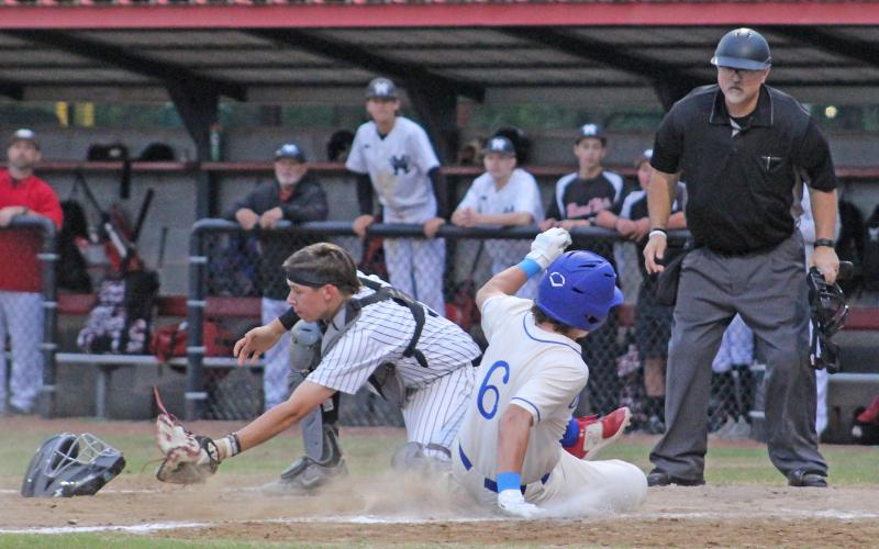 (TC GORDON | THE GRAHAM LEADER) Graham’s Tripp Mahaney slides into home plate to score a run while just beating the throw home during the Steers’ final game of the season. The Steers were fighting for a playoff spot but ended up with a 4-2 loss to end their year.