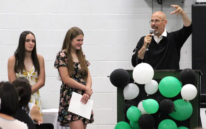 (TC GORDON | THE GRAHAM LEADER) Head girls basketball coach Ryan Dollar (right) talks about the incredible season the Ladycats basketball team had on their way to a state championship — the first in school history. Newcastle athletes were honored at the end-of-year sports banquet Tuesday, May 21.