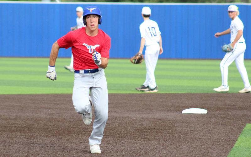 (TC GORDON | THE GRAHAM LEADER) Ty Thompson sprints for third base after stealing second and the opposing throw went into the outfield during Graham’s summer league baseball game Tuesday, June 11 against Jacksboro.
