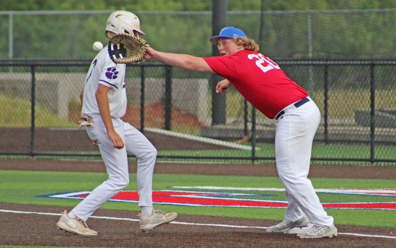 (TC GORDON | THE GRAHAM LEADER) First baseman Colter Johnson stretches to catch a pickoff throw and nearly tags the runner for an out Tuesday, June 11 in a summer league game against Jacksboro.