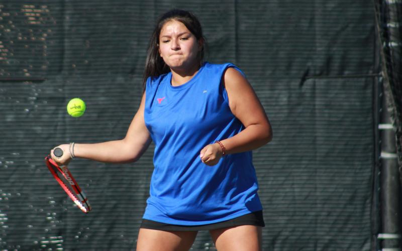 (TC GORDON | THE GRAHAM LEADER)Lady Blues tennis player Jade Dospapas swings hard at the ball during one of her singles matches in the fall tennis season. Dospapas earned All-District honors in the fall and qualified for regionals in the spring season.