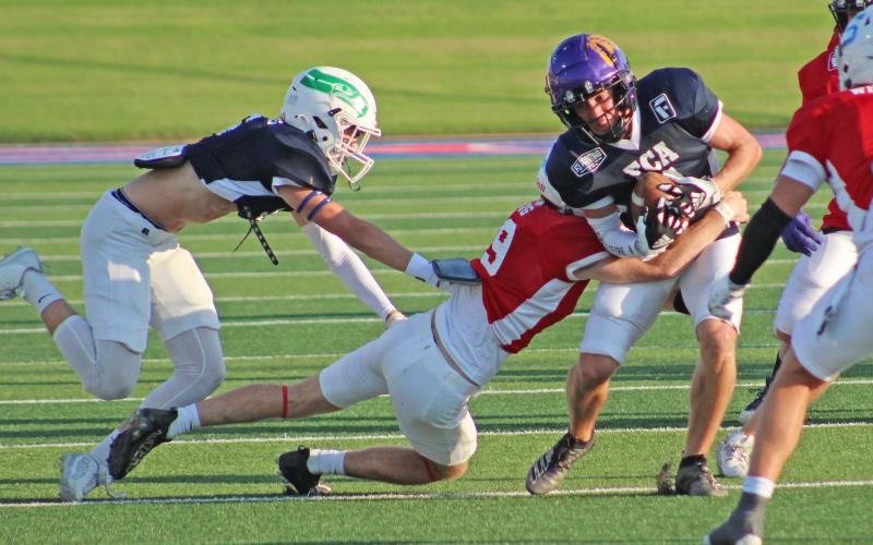(TC GORDON | THE GRAHAM LEADER) Former Newcastle Bobcat Isaac King (red tackler) brings down a blue team ball handler during the FCA Big Country Myrle Greathouse All-Star Football Classic last Saturday, June 15 in Abilene.