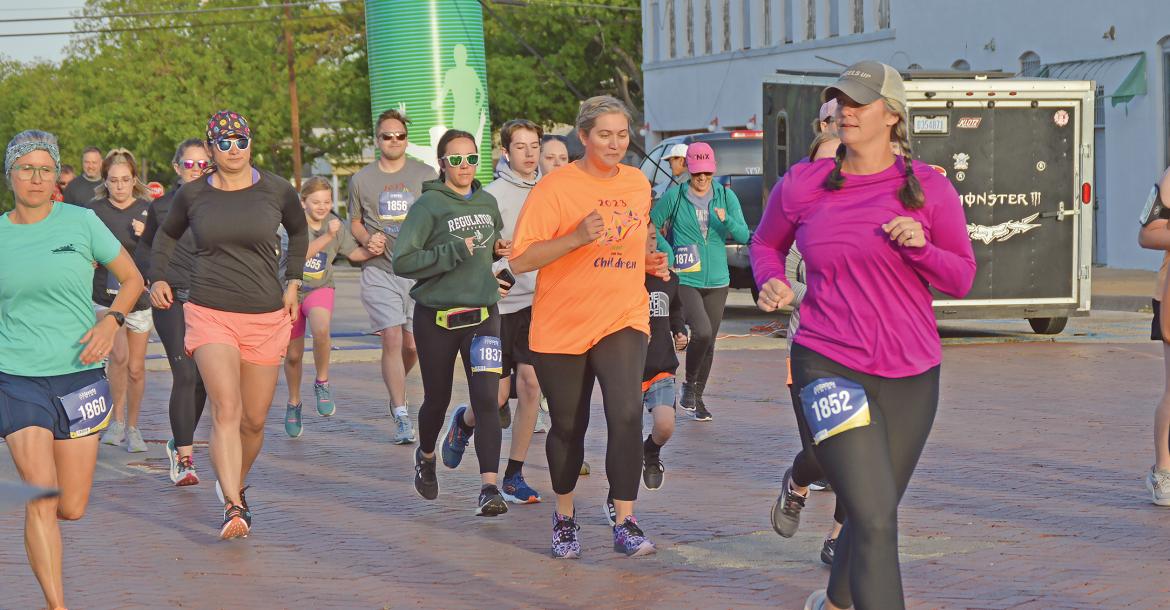 (THE GRAHAM LEADER | ARCHIVE PHOTO) Runners in the 5K race of the Run for the Children take off from the starting line at Third Street and Oak Street in 2023. The race this year will start and end at the same location Saturday, April 27.